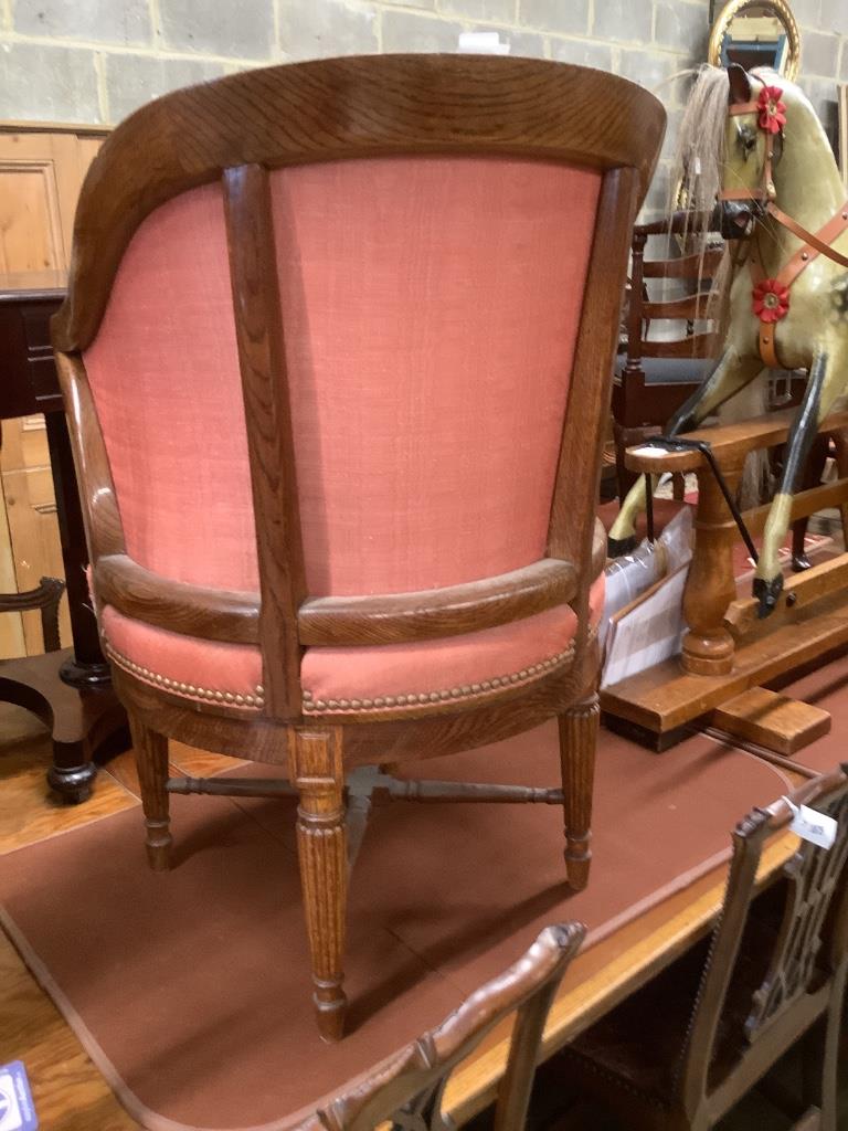 A Victorian oak revolving desk chair, by Waring & Sons Ltd of London, width 57cm